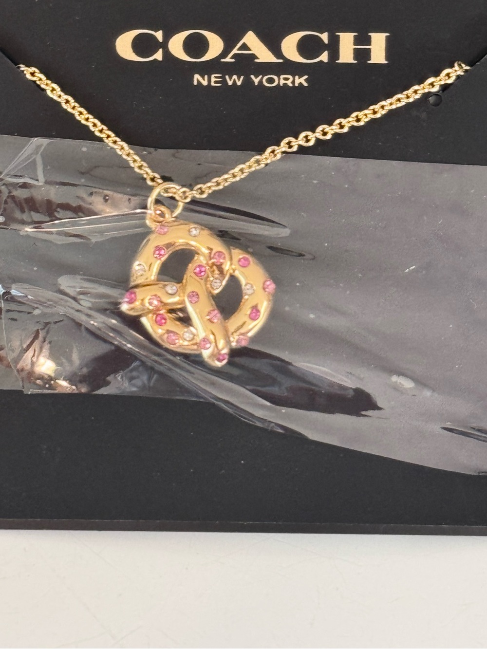 Coach Gold Pretzel Pendant Necklace with Pink Accents